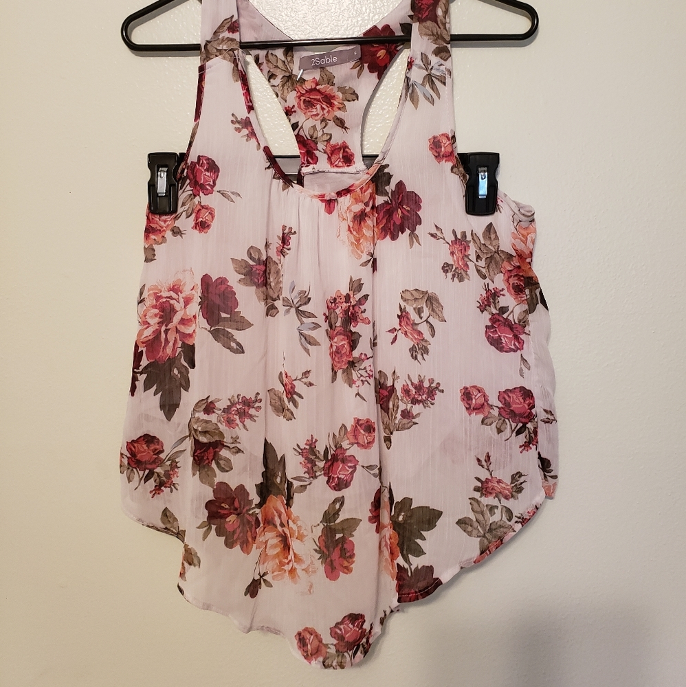 Red rose on white blouse.
